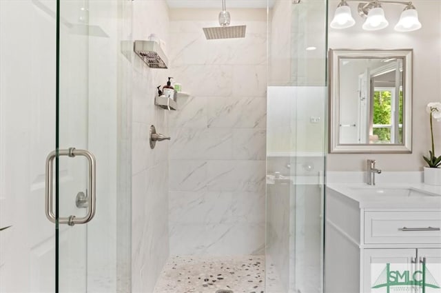 full bath with a stall shower and vanity