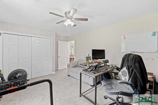 carpeted home office featuring a ceiling fan