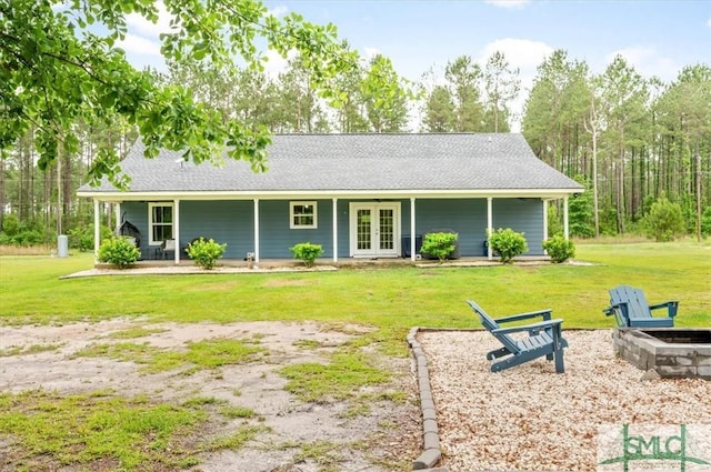 view of front of house featuring french doors, a front yard, and a fire pit