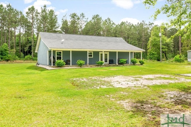 view of front of house featuring a front lawn and french doors