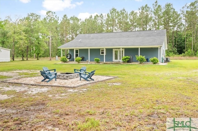 back of property featuring an outdoor fire pit, a yard, french doors, and a patio