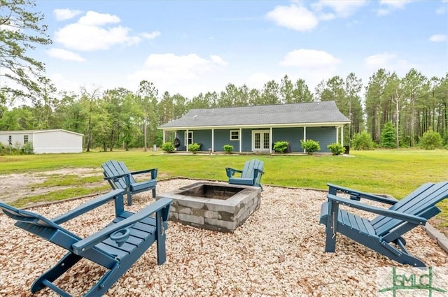 view of home's community featuring a fire pit and a lawn