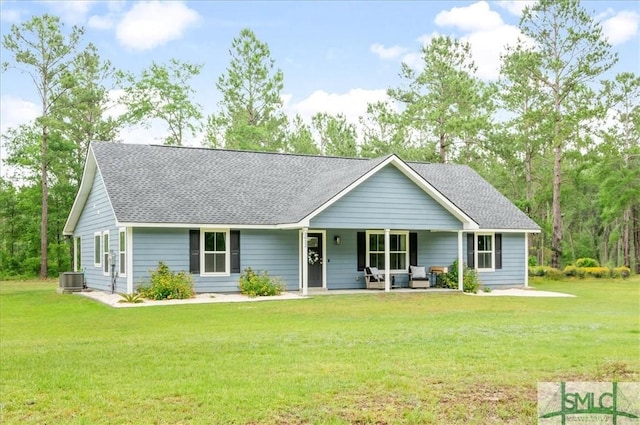 ranch-style house featuring a front lawn, a shingled roof, and central AC unit
