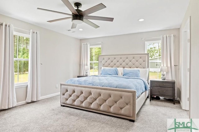 carpeted bedroom featuring multiple windows, baseboards, recessed lighting, and ceiling fan