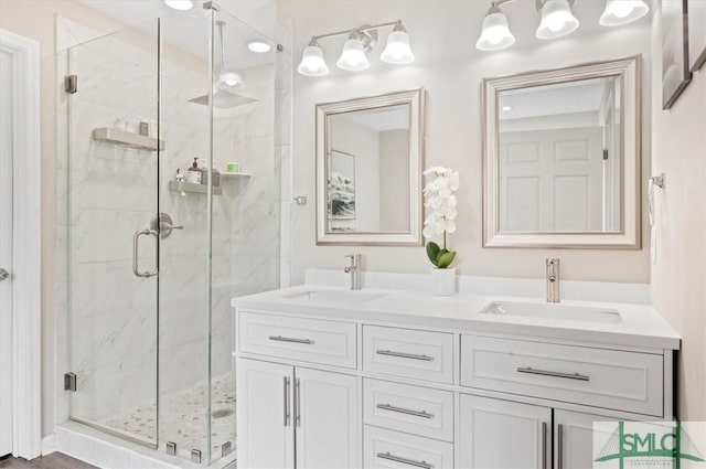 full bath with a marble finish shower and double vanity