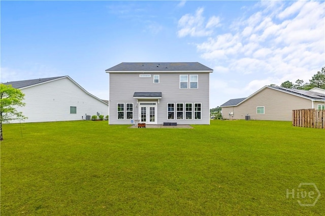rear view of house featuring a yard, french doors, central AC unit, and a patio area