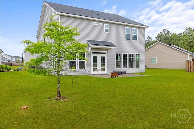back of house with a patio area, a yard, and french doors