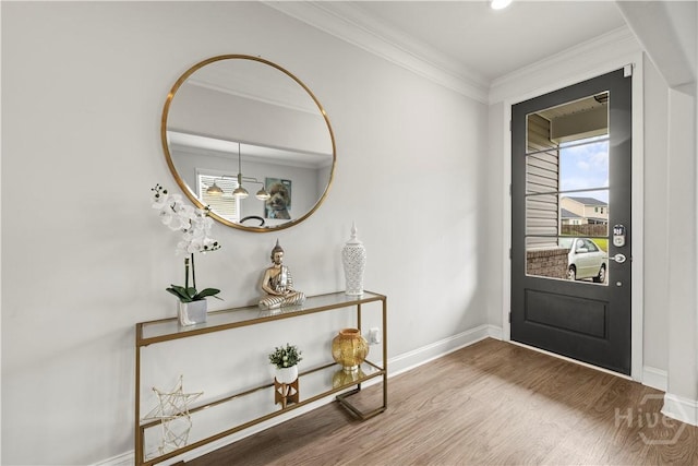 entrance foyer with crown molding, wood finished floors, and baseboards
