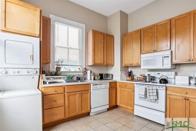 546548 E Huntingdon St, Savannah, GA 31401 - kitchen with white appliances, stacked washer / dryer, light countertops, and light tile patterned flooring