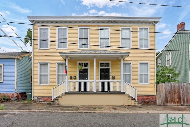 546548 E Huntingdon St, Savannah, GA 31401 - townhome / multi-family property featuring a porch, a standing seam roof, fence, and metal roof