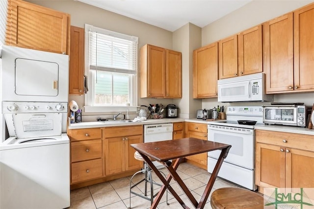 546548 E Huntingdon St, Savannah, GA 31401 - kitchen with white appliances, estacked washer and dryer, light countertops, and a sink