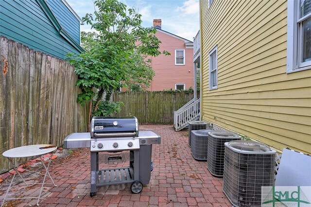 546548 E Huntingdon St, Savannah, GA 31401 - view of patio with cooling unit, a fenced backyard, and area for grilling