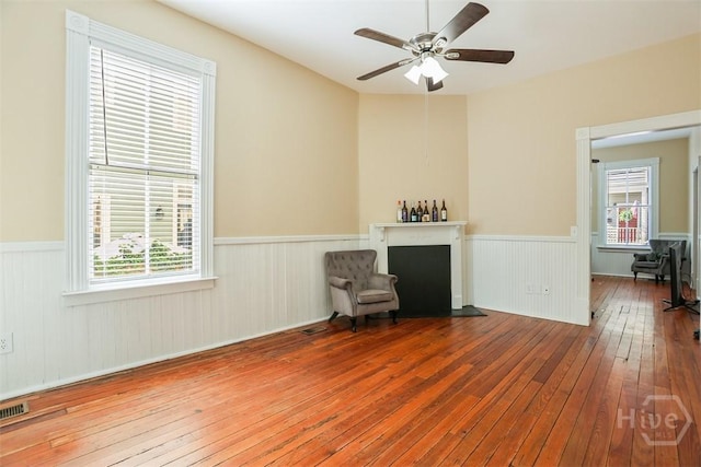 546548 E Huntingdon St, Savannah, GA 31401 - unfurnished room featuring wainscoting, hardwood / wood-style floors, ceiling fan, and plenty of natural light