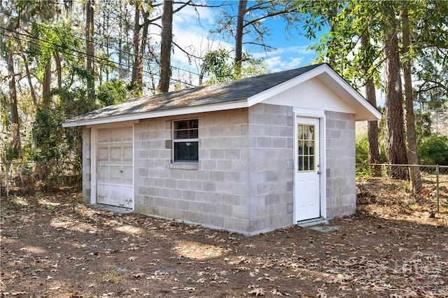 view of outbuilding with fence and an outdoor structure