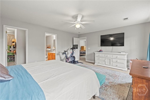 carpeted bedroom featuring baseboards, ceiling fan, and ensuite bathroom