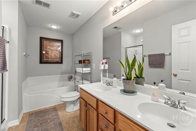 bathroom featuring tile patterned flooring, a stall shower, a bath, double vanity, and toilet