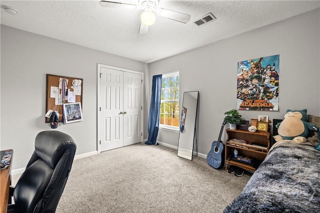 office space with carpet flooring, ceiling fan, a textured ceiling, and baseboards
