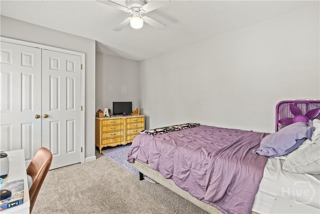 carpeted bedroom featuring a closet and a ceiling fan