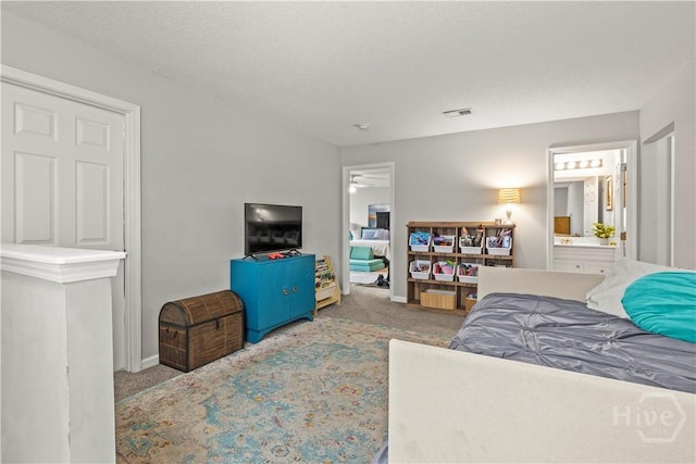 carpeted bedroom with baseboards and connected bathroom