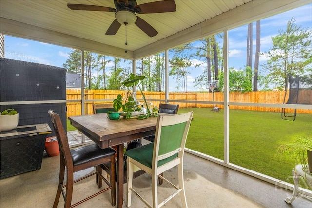 sunroom with ceiling fan and outdoor dining space