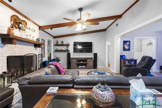 living room featuring a ceiling fan, a fireplace, wood finished floors, and ornamental molding