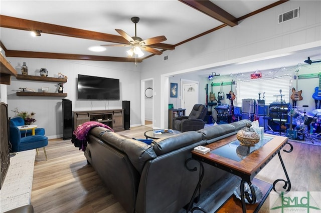 living area featuring beam ceiling, a ceiling fan, and wood finished floors