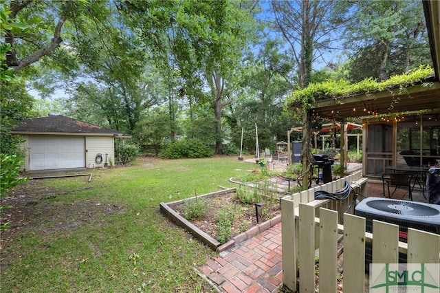 8 Chowning Dr, Savannah, GA 31419 - view of green lawn with a vegetable garden, a garage, an outbuilding, and view of wooded area