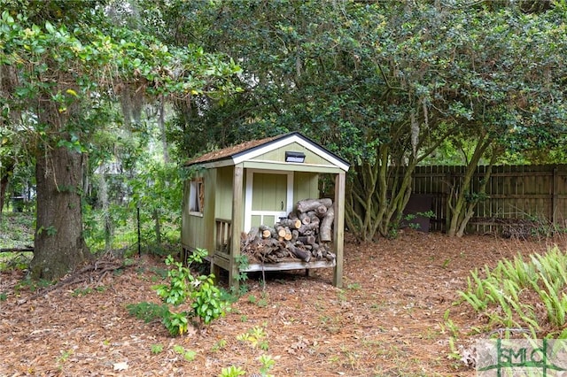 view of shed featuring fence