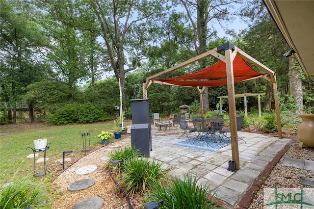 view of patio / terrace featuring outdoor dining area and view of scattered trees