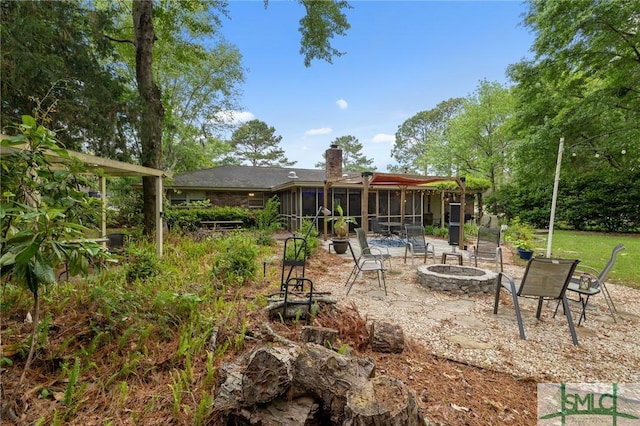 8 Chowning Dr, Savannah, GA 31419 - rear view of property with an outdoor fire pit, a sunroom, a chimney, and a patio