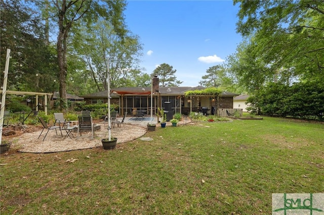 rear view of property featuring a sunroom, a lawn, a patio, and a chimney