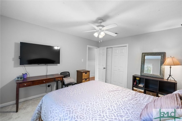 carpeted bedroom featuring a closet, ceiling fan, and baseboards