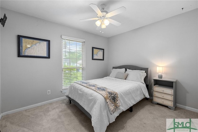 bedroom featuring light colored carpet, baseboards, and ceiling fan