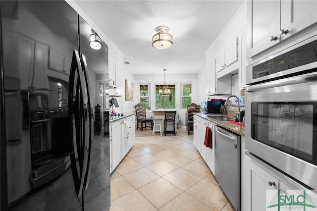 8 Chowning Dr, Savannah, GA 31419 - kitchen featuring appliances with stainless steel finishes, a sink, white cabinets, and a textured ceiling