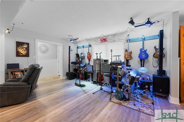 recreation room with wood finished floors and baseboards