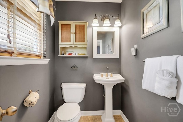 506 Butler Ave, Tybee Island, GA 31328 - half bath with toilet, baseboards, and a sink