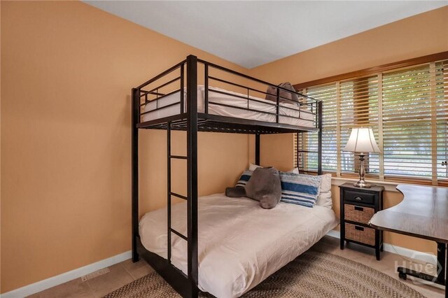 506 Butler Ave, Tybee Island, GA 31328 - bedroom with baseboards and tile patterned flooring