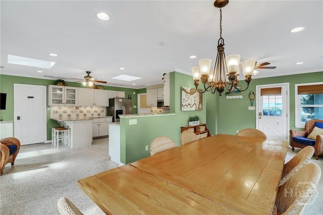 506 Butler Ave, Tybee Island, GA 31328 - dining space featuring ceiling fan, a skylight, a chandelier, recessed lighting, and dark aggregate flooring