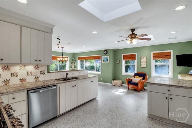 506 Butler Ave, Tybee Island, GA 31328 - kitchen featuring dishwasher, a sink, a skylight, baseboards, and a peninsula