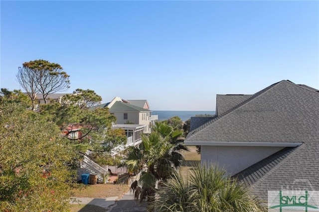 506 Butler Ave, Tybee Island, GA 31328 - view of side of home featuring roof with shingles and stucco siding