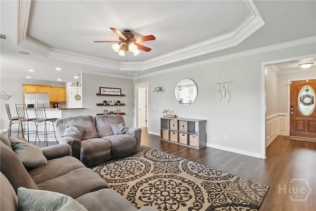 509 Braves Field Dr, Guyton, GA 31312 - living room with a tray ceiling, a ceiling fan, crown molding, and dark wood-style floors