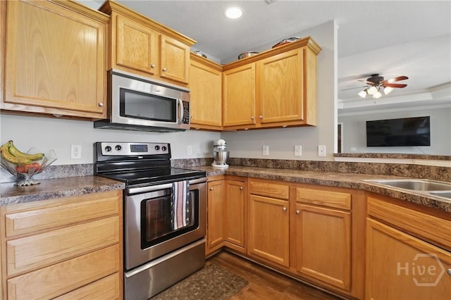 509 Braves Field Dr, Guyton, GA 31312 - kitchen featuring appliances with stainless steel finishes, dark countertops, dark wood-style floors, a ceiling fan, and recessed lighting