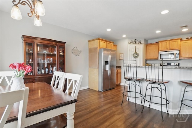 509 Braves Field Dr, Guyton, GA 31312 - kitchen featuring appliances with stainless steel finishes, a kitchen breakfast bar, dark wood-style floors, light countertops, and recessed lighting