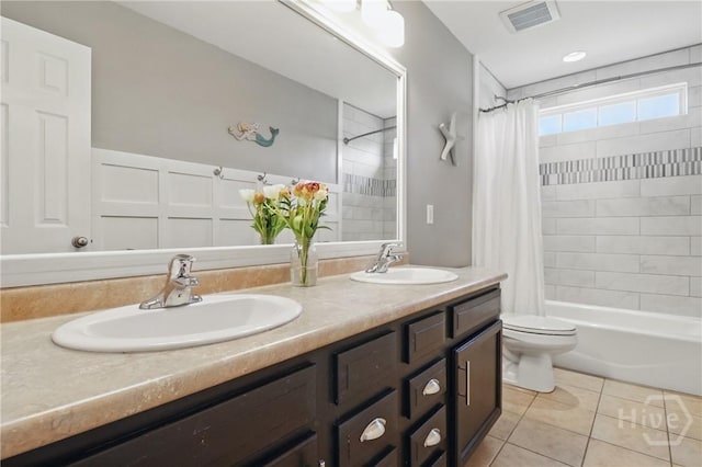 509 Braves Field Dr, Guyton, GA 31312 - bathroom featuring tile patterned floors, toilet, shower / tub combo, double vanity, and wainscoting