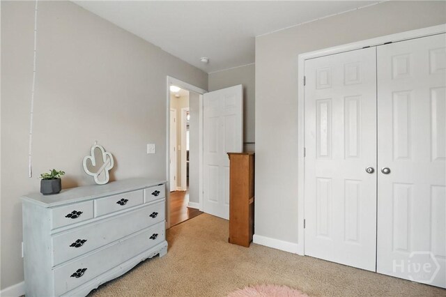 509 Braves Field Dr, Guyton, GA 31312 - bedroom with light carpet, a closet, and baseboards