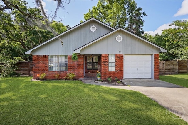 1405 Desert Storm Dr, Hinesville, GA 31313 - view of front of home with driveway, brick siding, and a garage