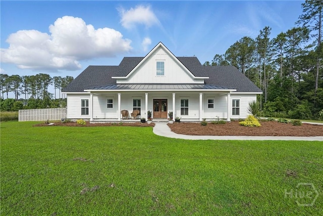modern inspired farmhouse with a standing seam roof, french doors, a porch, metal roof, and a shingled roof