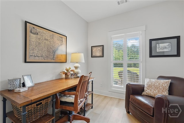 office space with light wood-type flooring and baseboards