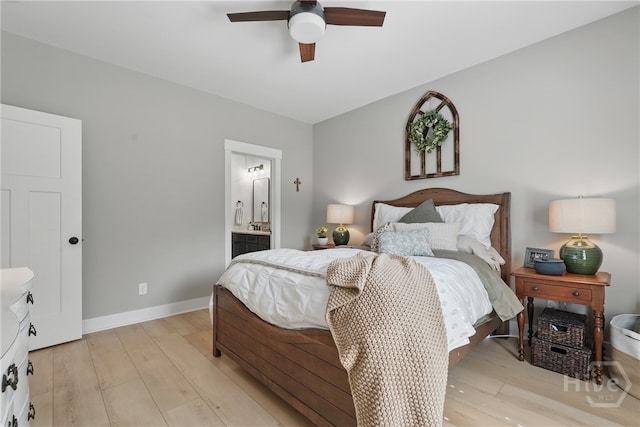 bedroom with light wood-style flooring, baseboards, ensuite bath, and ceiling fan
