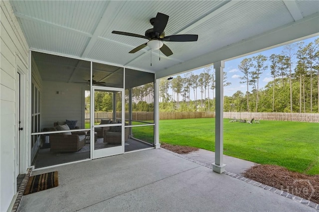 unfurnished sunroom featuring a ceiling fan and healthy amount of natural light